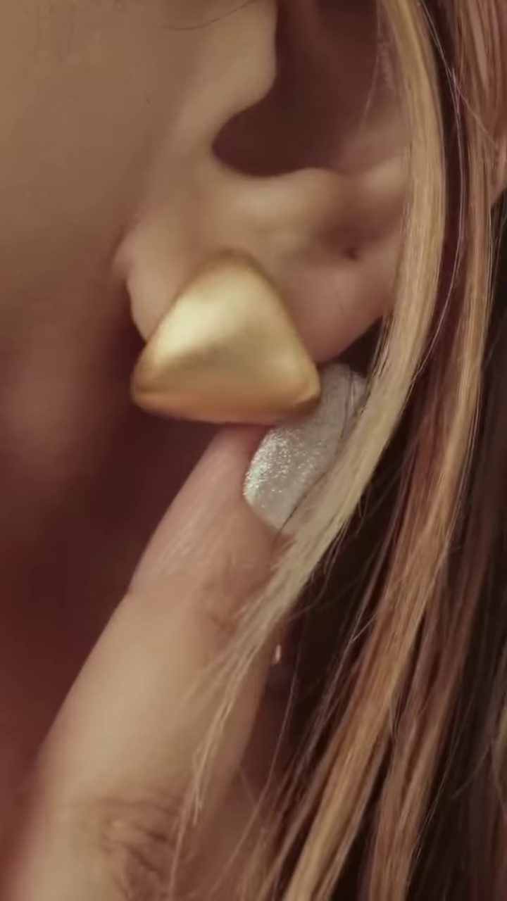 Close-Up of Stylish Gold-Toned Earrings: Teardrop, Stud, and Mesh Hoop