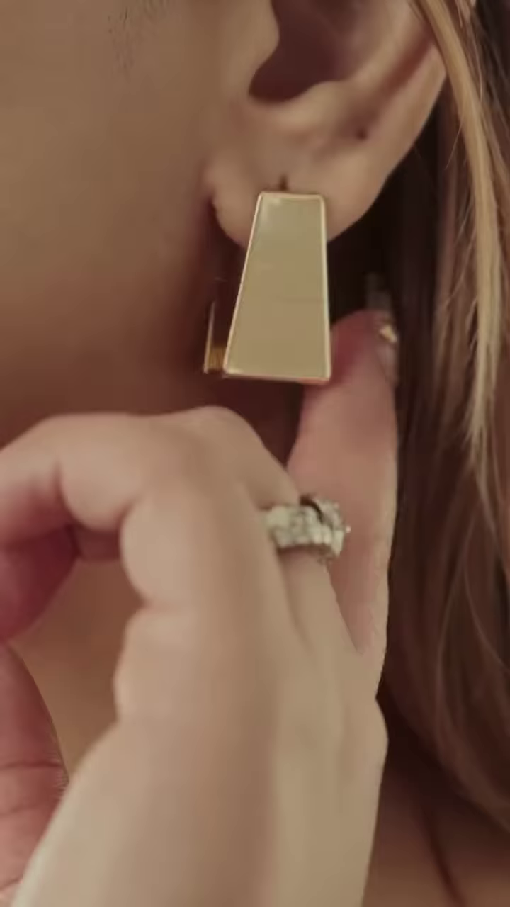 Close-Up of Stylish Gold-Toned Earrings: Teardrop, Stud, and Mesh Hoop