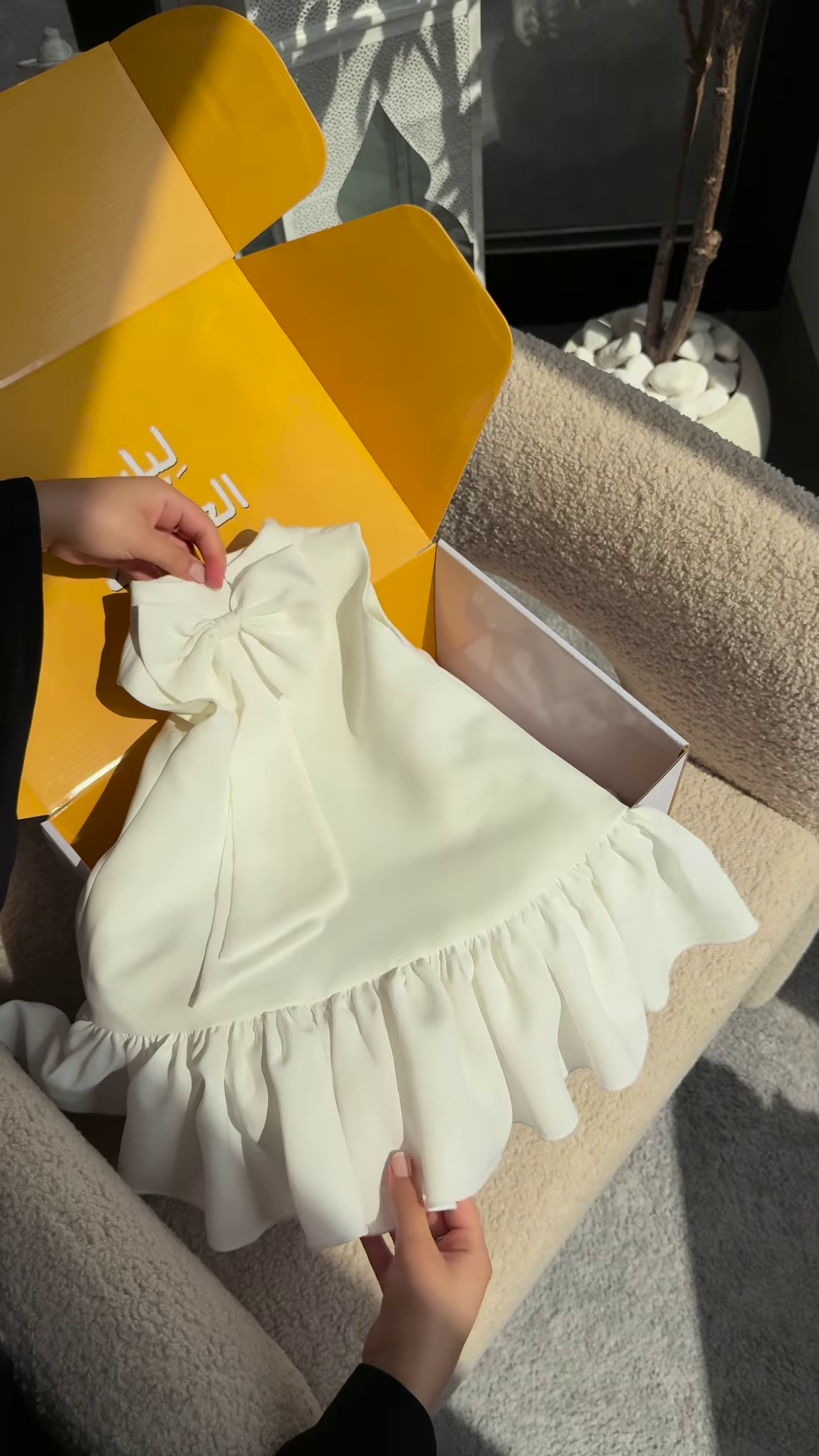 Elegant White Dress with Ruffled Hem and Bow Detail