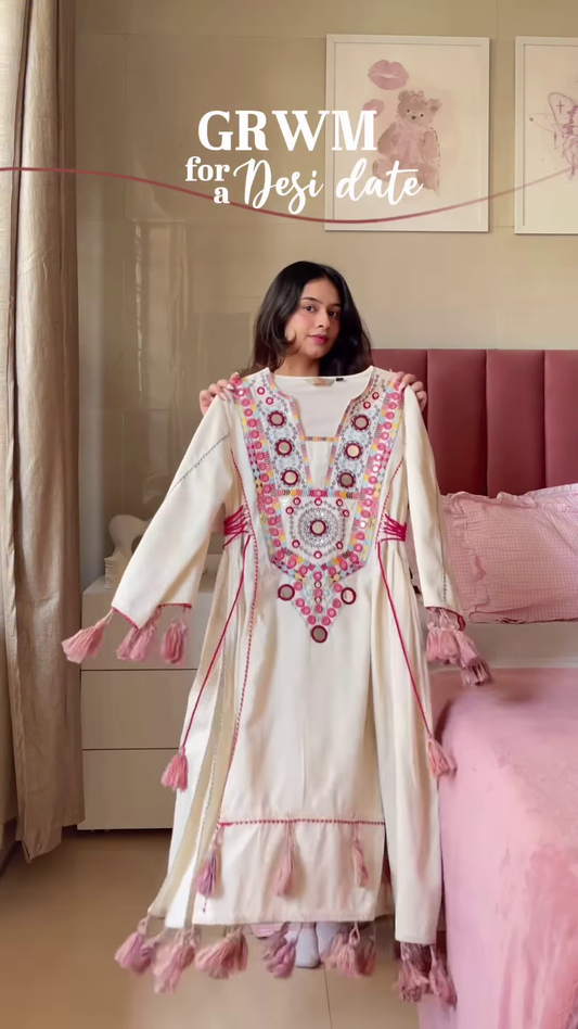 Cream-Colored Embroidered Traditional Dress with Colorful Circular Motifs and Pink Tassel Accents