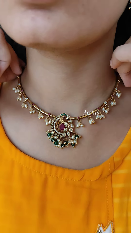 Elegant Gold-Toned Hasli Necklace with Peacock Pendant, Kundan, and Pearl Drops