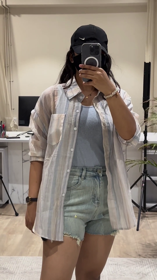 Casual Layered Outfit: Pink Button-Down Shirt, Tank Top, and Denim Shorts