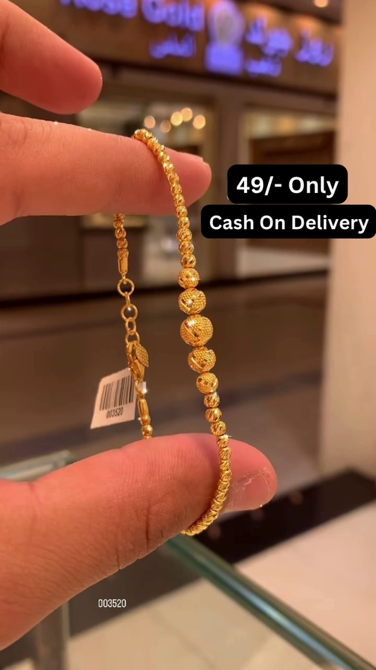 Elegant Gold-Toned Beaded Bracelet with Intricately Patterned Spherical Accents